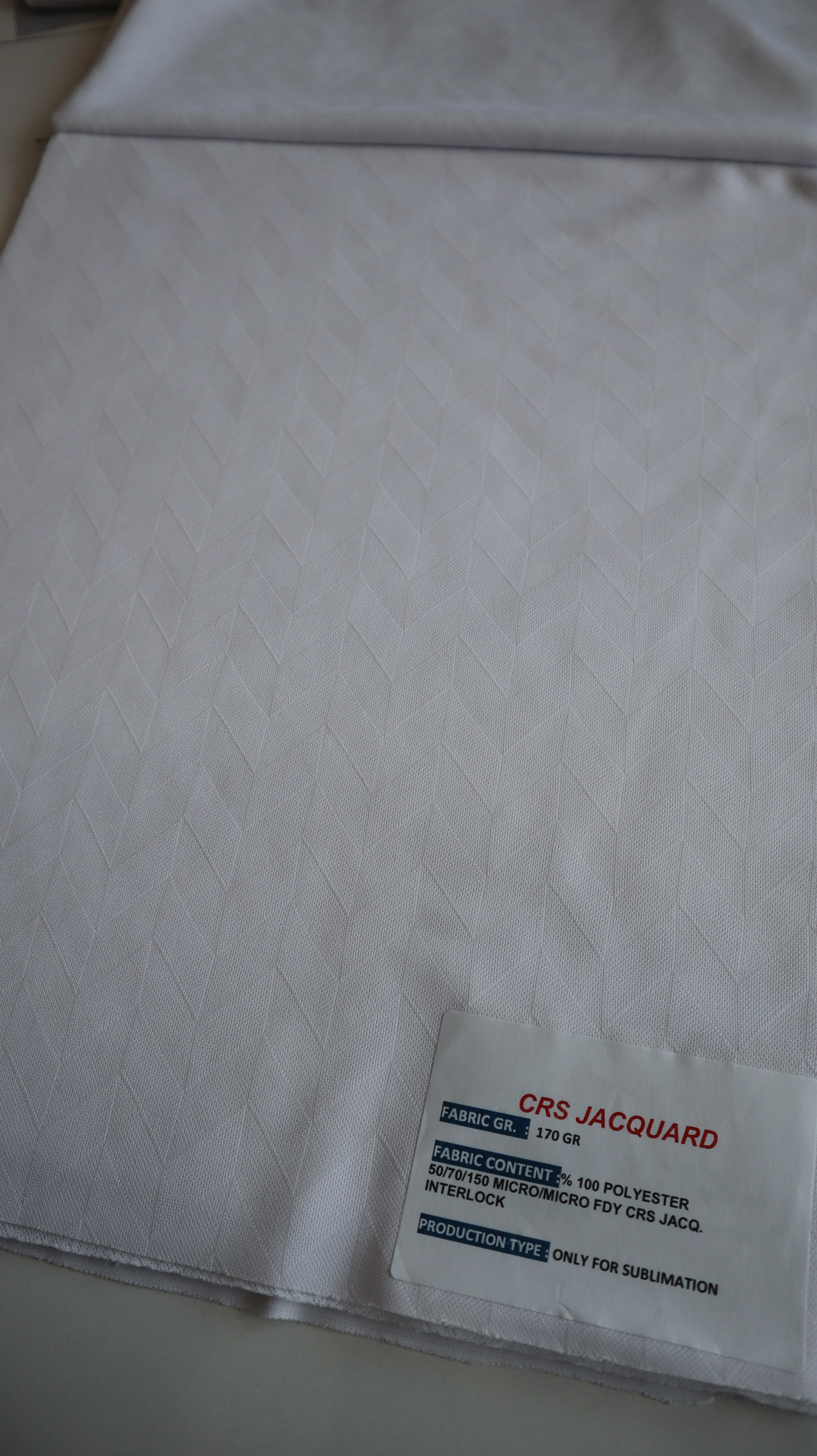 Performance sportswear fabric construction close-up showing knit surface and stretch