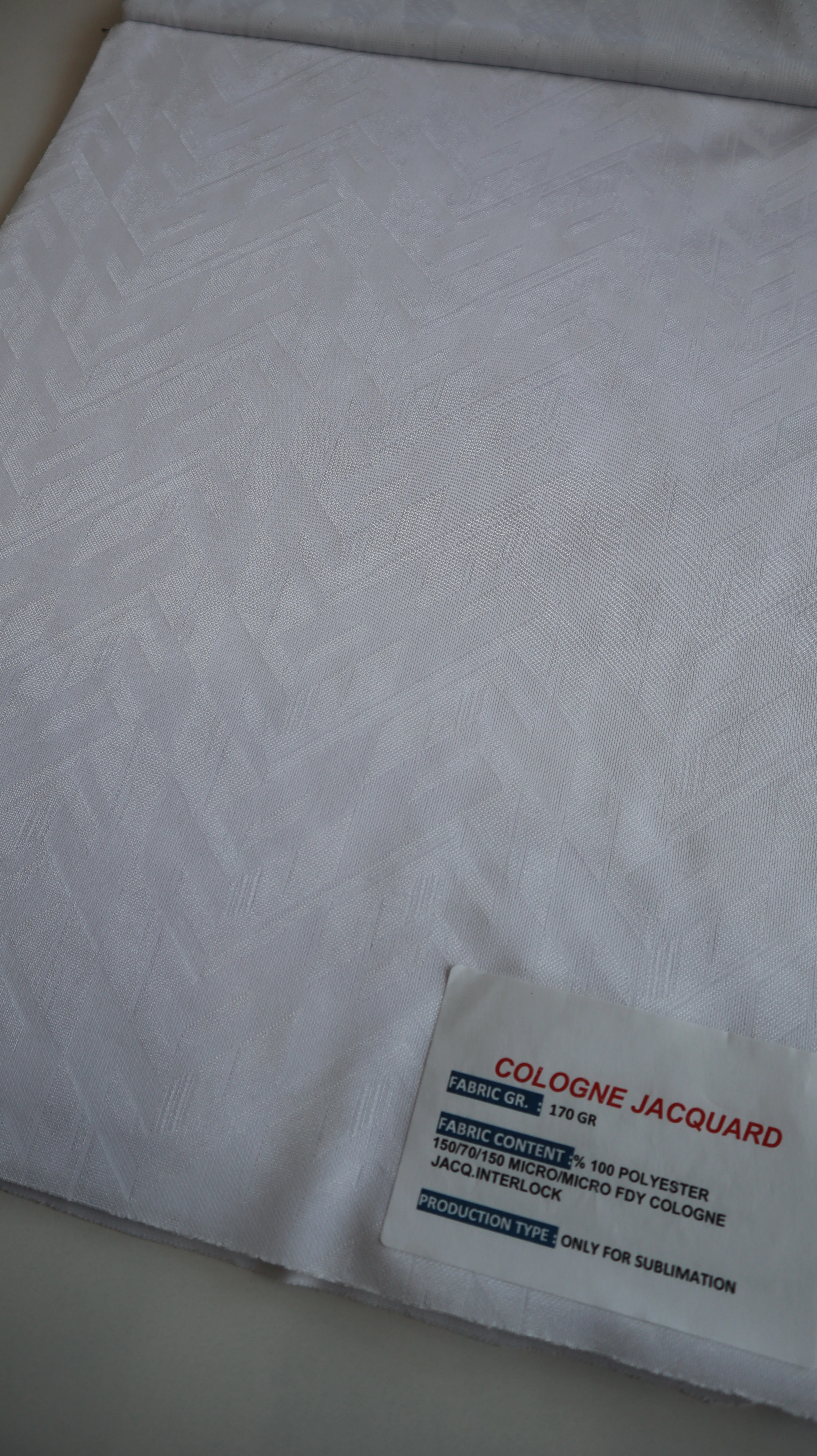 Performance sportswear fabric construction close-up showing knit surface and stretch