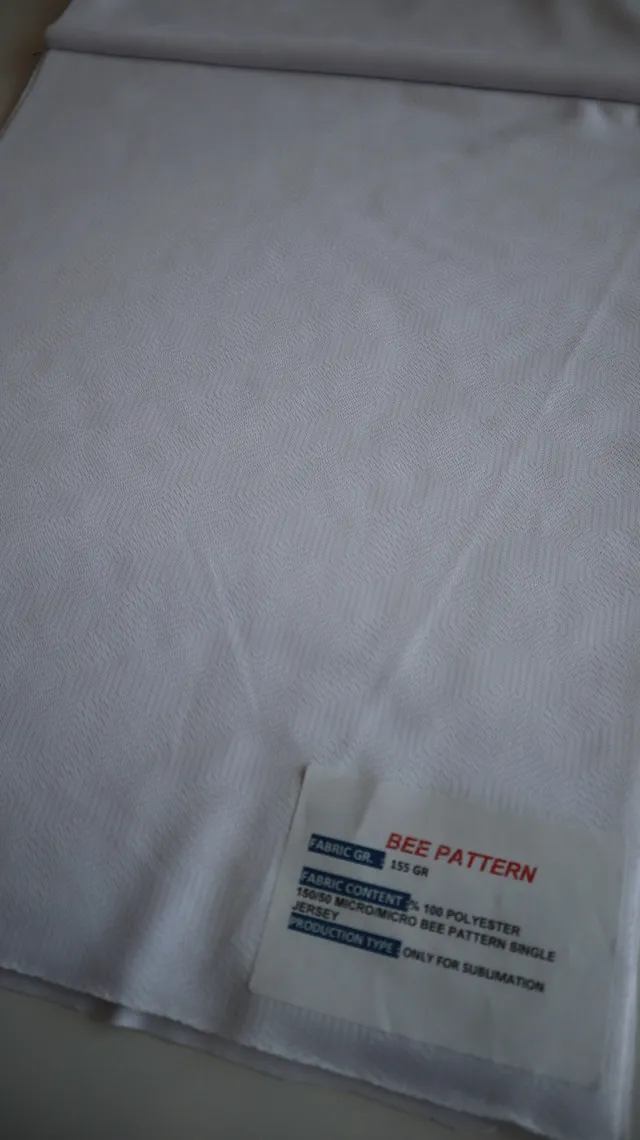 Performance sportswear fabric construction close-up showing knit surface and stretch — 2