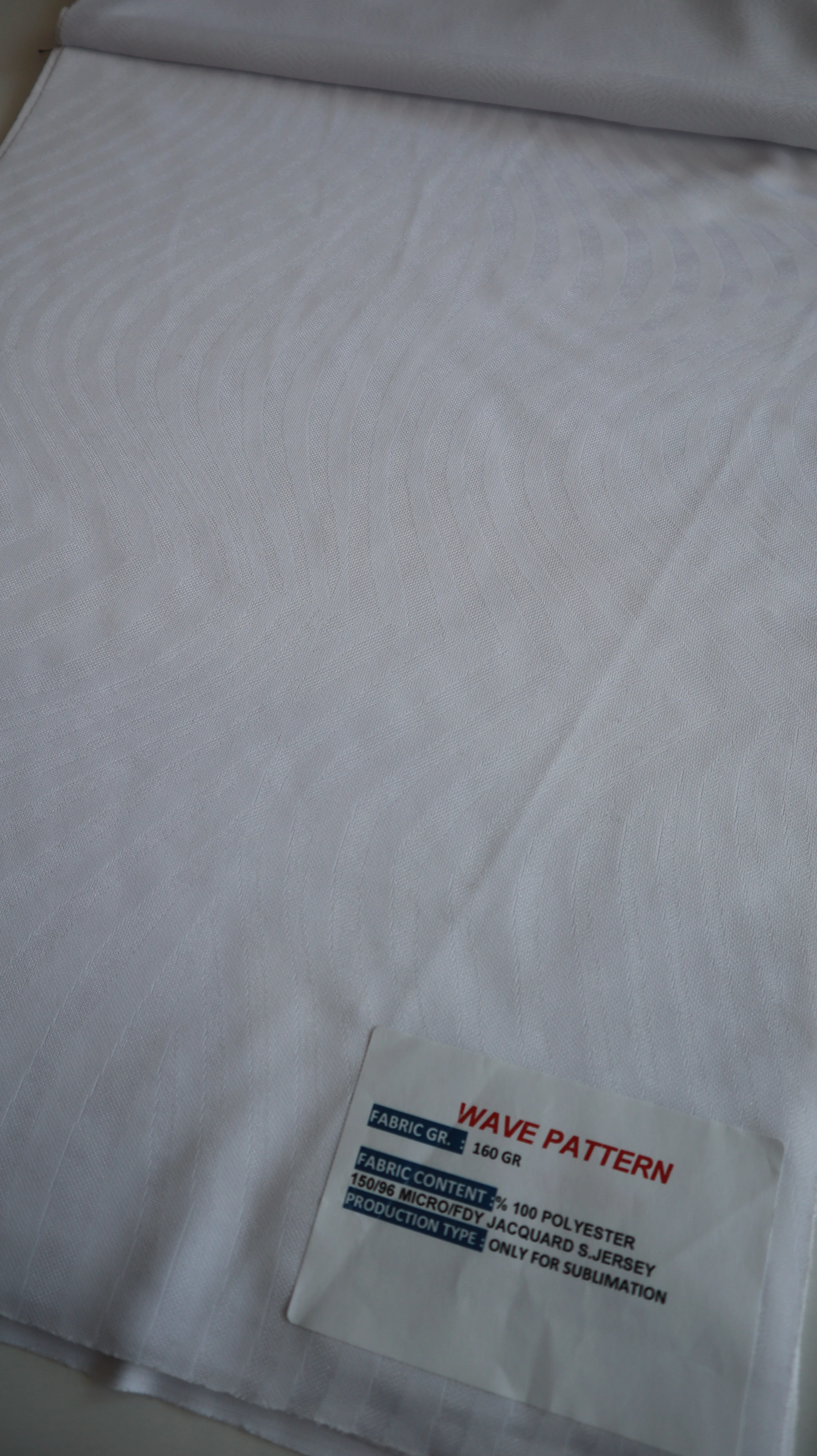 Performance sportswear fabric construction close-up showing knit surface and stretch