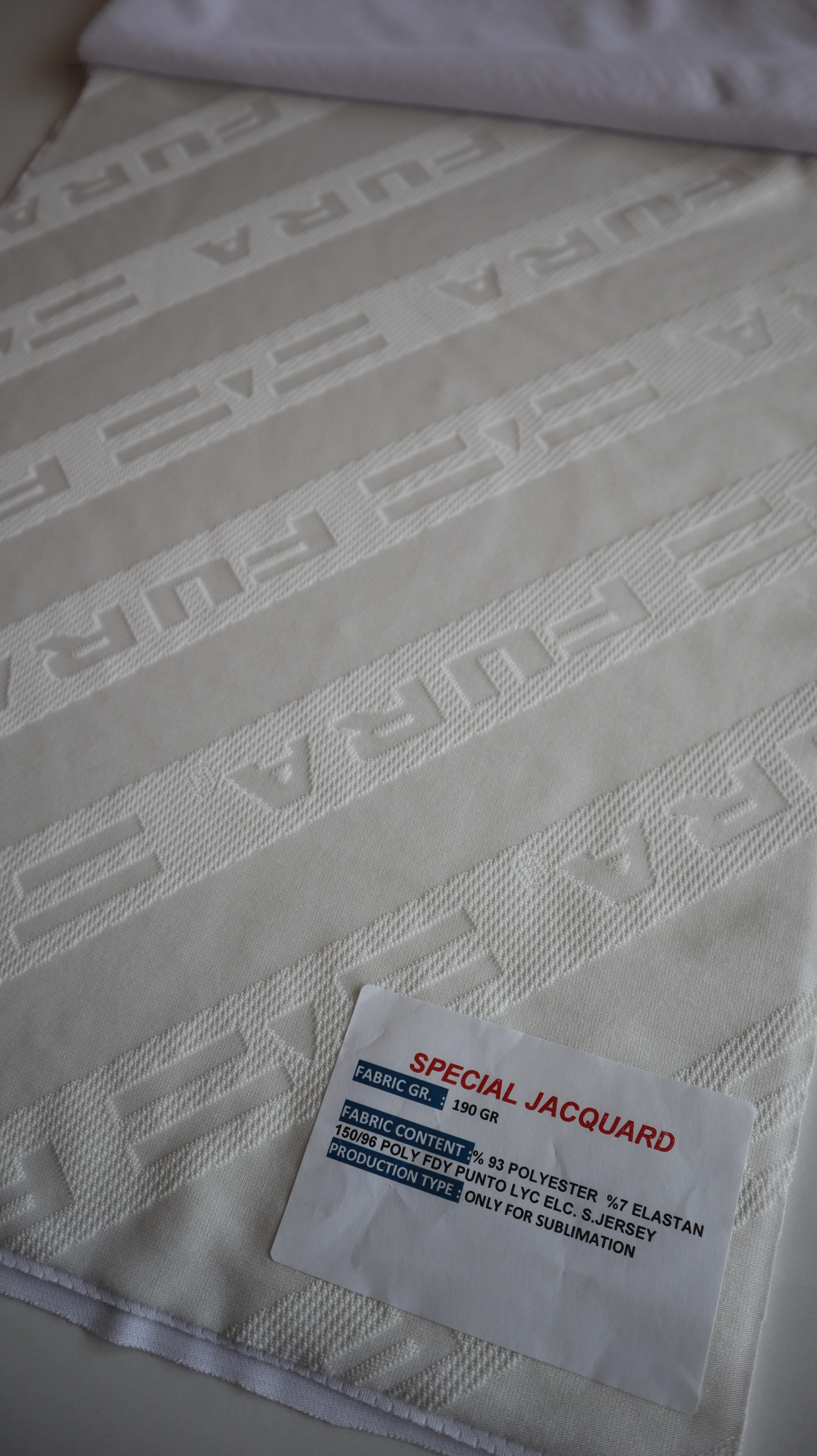 Performance sportswear fabric construction close-up showing knit surface and stretch