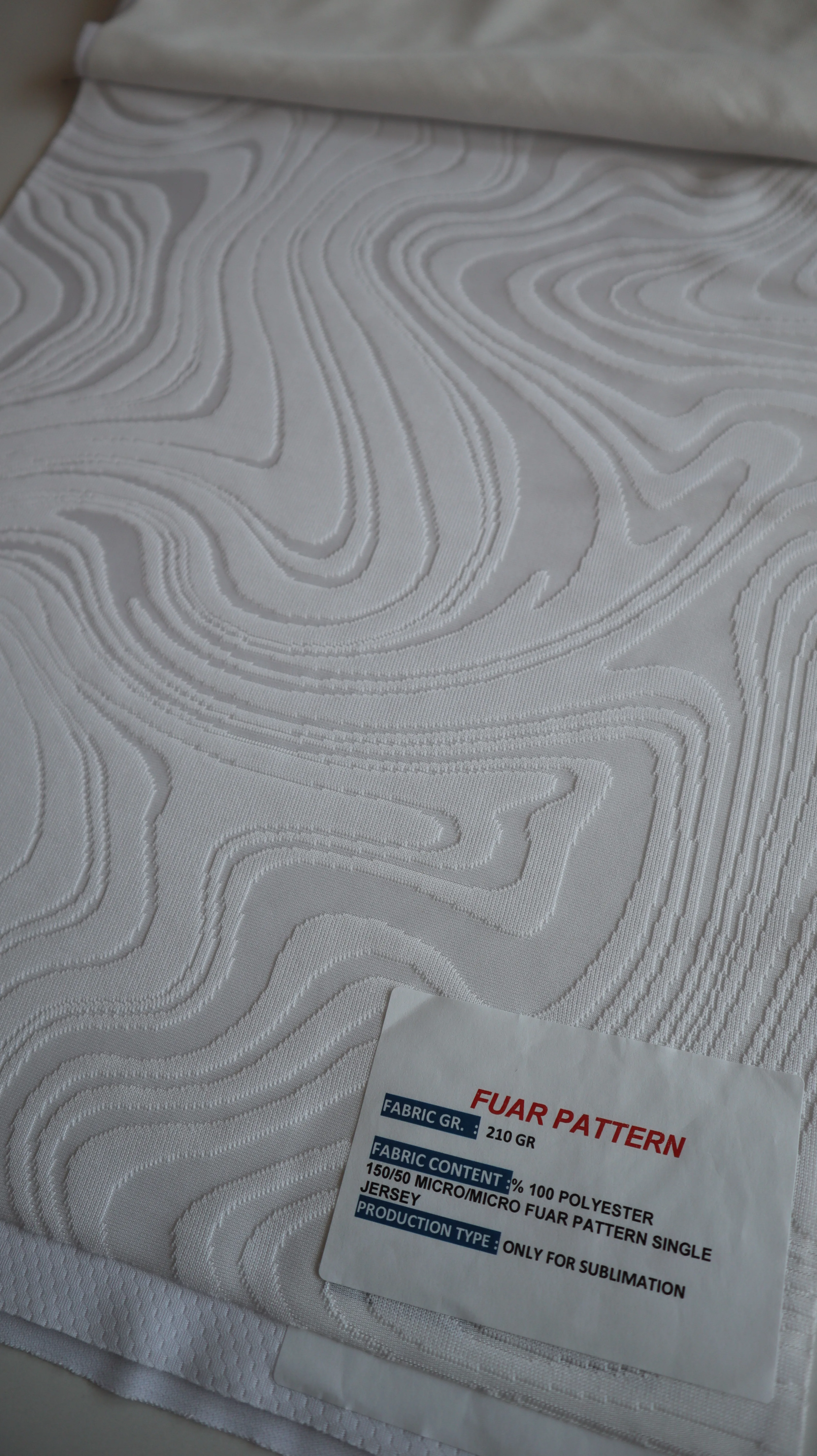 Performance sportswear fabric construction close-up showing knit surface and stretch