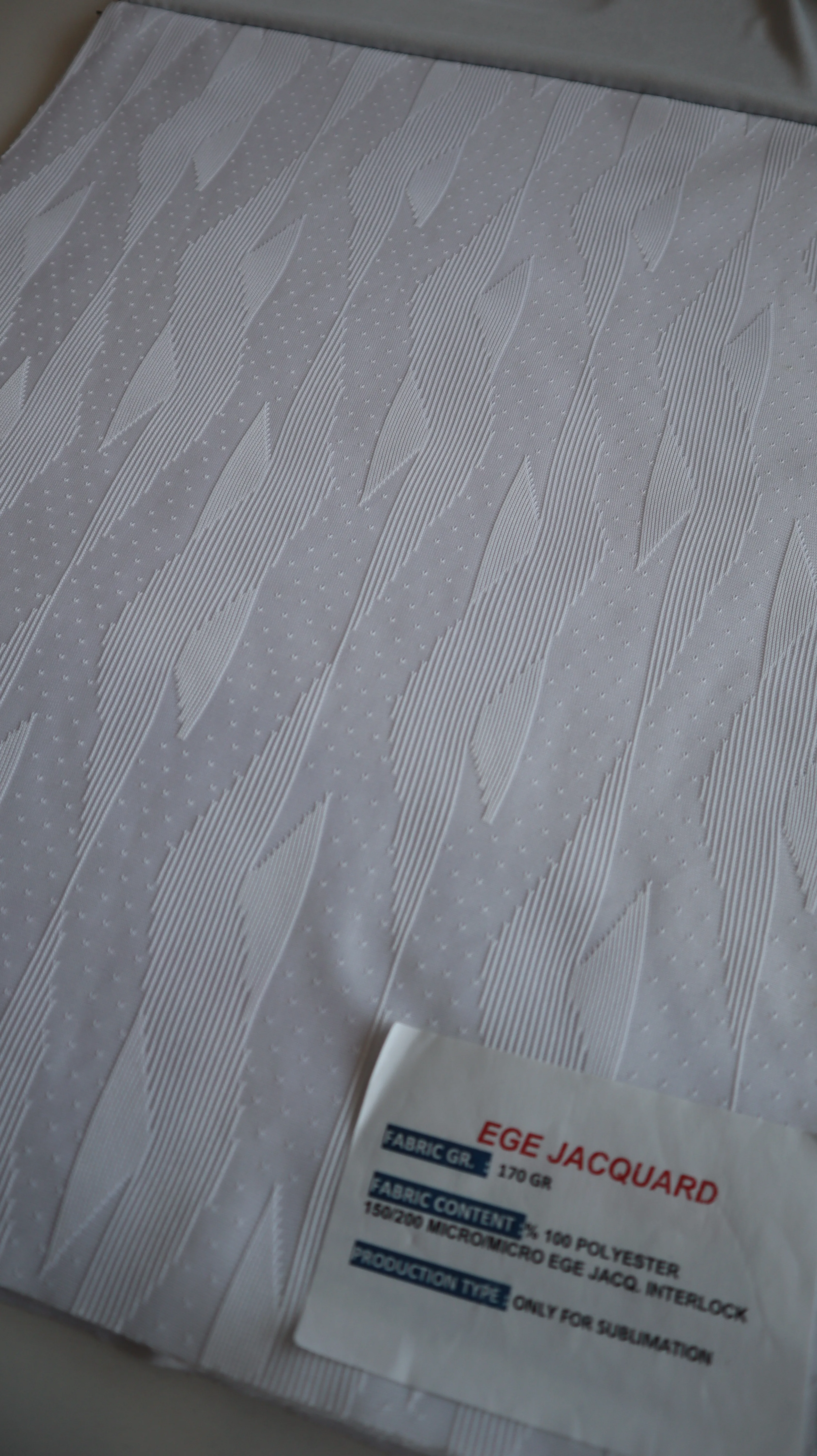 Performance sportswear fabric construction close-up showing knit surface and stretch